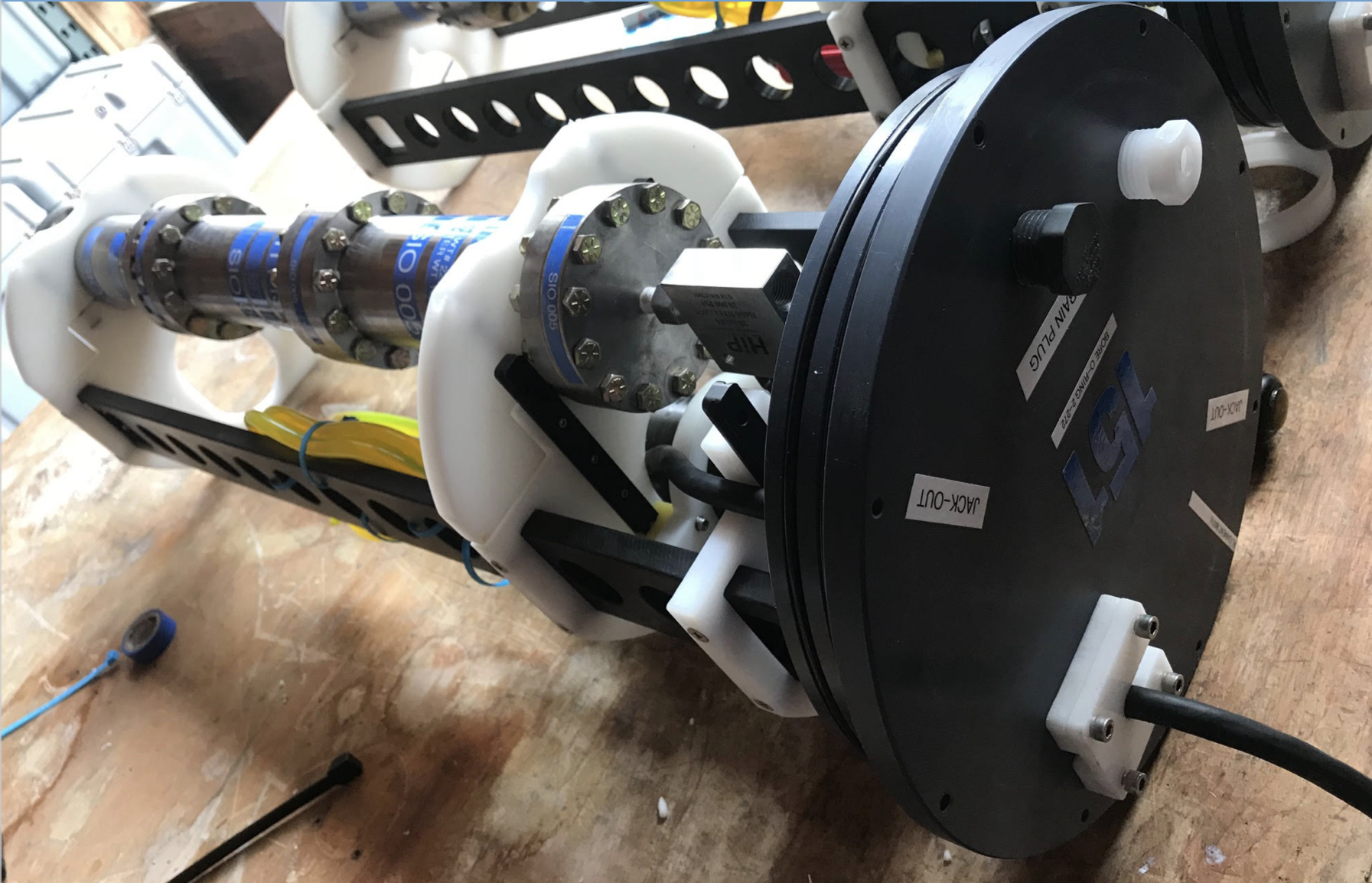Internal components of the Pressure Retaining Sampler (PRS) that are mounted to the inside rails that insert to the plastic casing that is secured to the side of the DAP frame. Matthew Norenberg, Senior Marine Mechanician, originated and optimized this mount-casing design. Photo courtesy of Alvaro Munoz Plominsky.