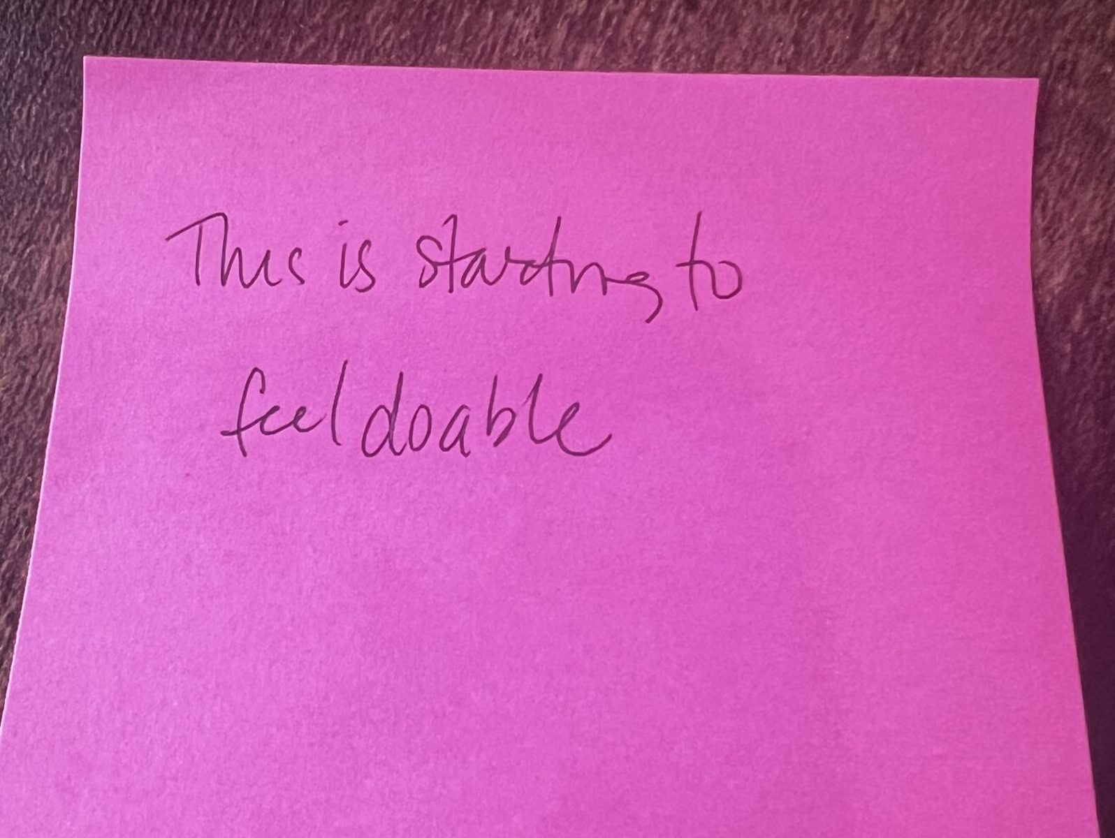 Anonymous participant feedback shared on a sticky-note during a workshop check-in that states 'This is starting to feel doable.'